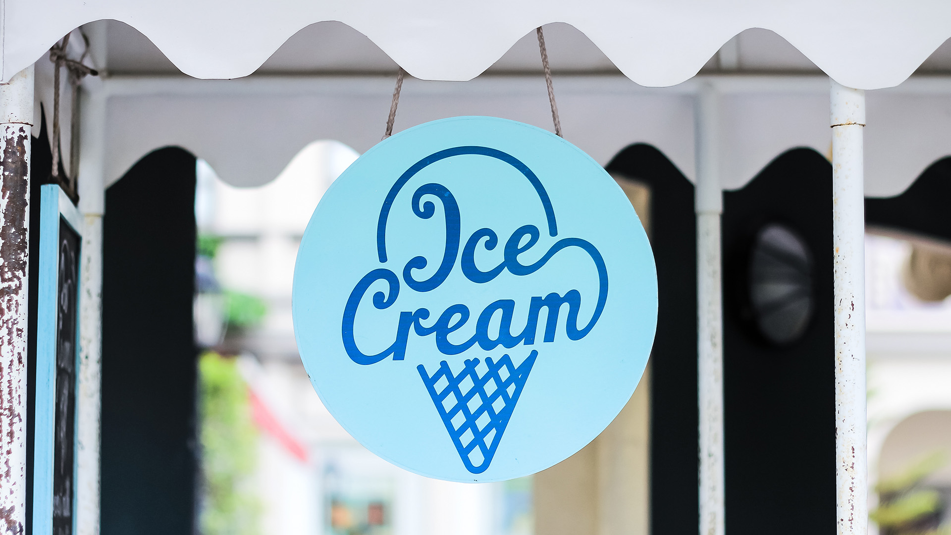 Blue circle Ice Cream sign hanging from a building