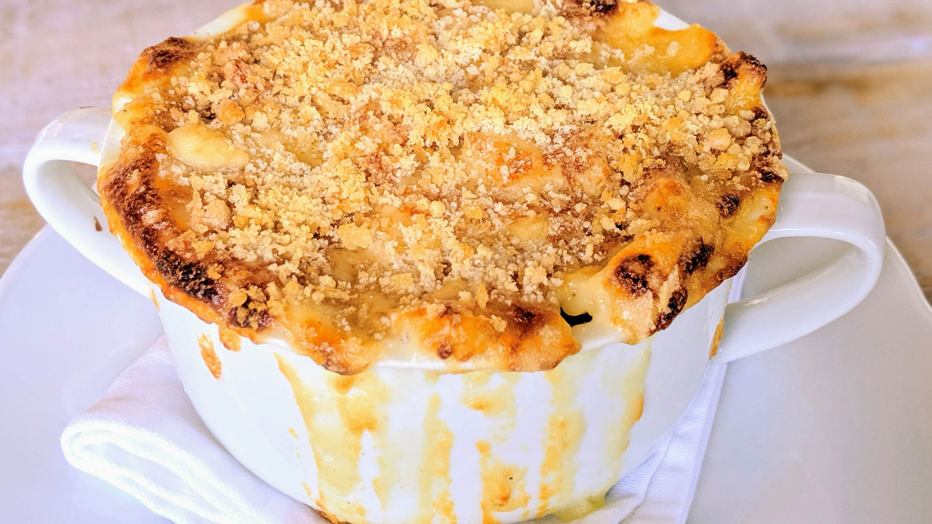 Baked mac and cheese in small round white dish.